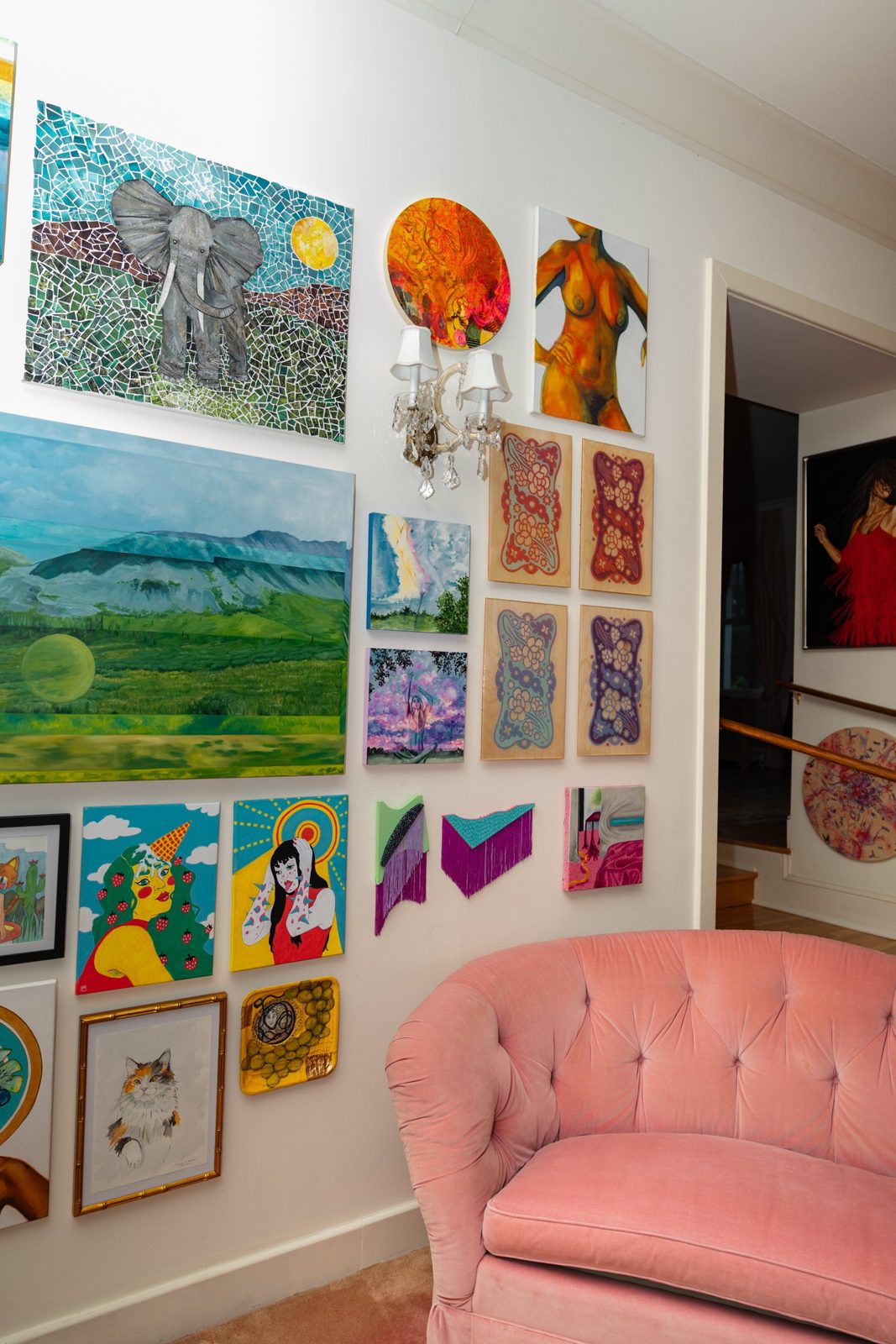 The pink sofa wall at Girlism, hung floor to ceiling